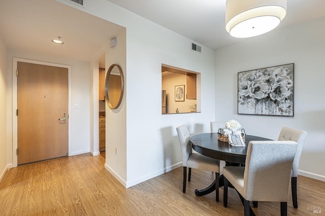 dining space with light hardwood / wood-style floors