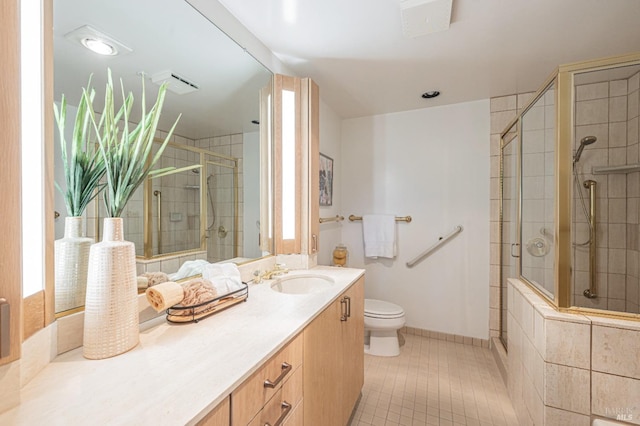 bathroom with vanity, toilet, tile patterned floors, and an enclosed shower