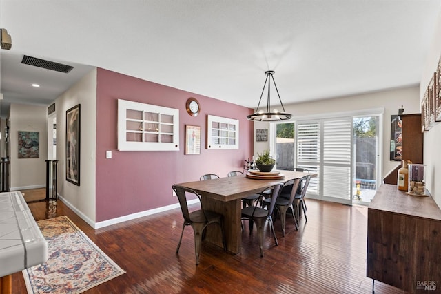 dining space with dark hardwood / wood-style flooring