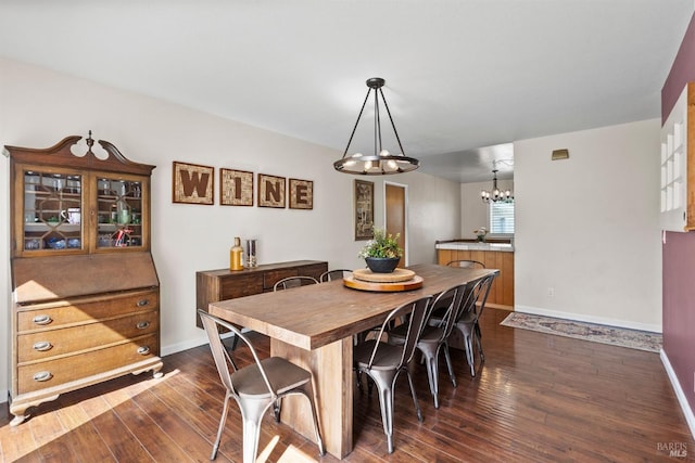 dining space featuring a notable chandelier and dark hardwood / wood-style floors