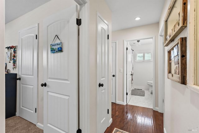 corridor with dark hardwood / wood-style flooring