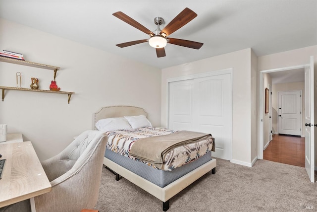 bedroom featuring ceiling fan, light colored carpet, and a closet