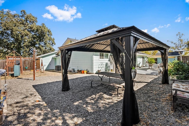 back of house with a gazebo, a patio area, a playground, and cooling unit