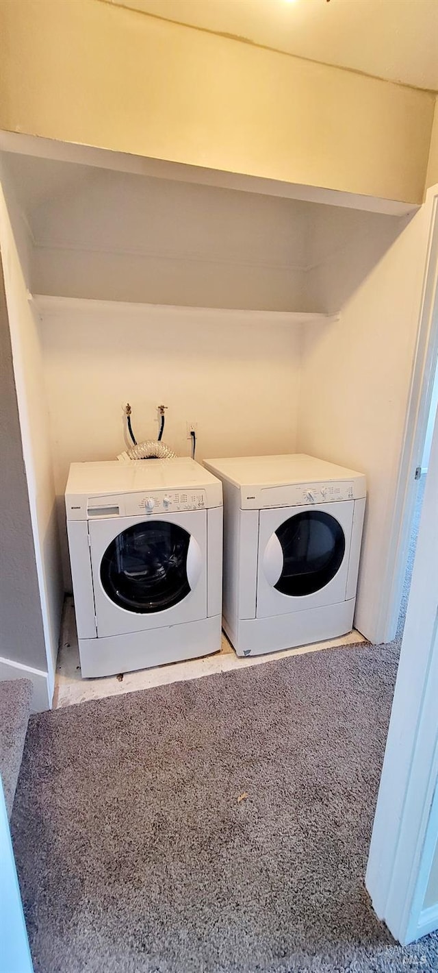 laundry room featuring light carpet and washing machine and clothes dryer