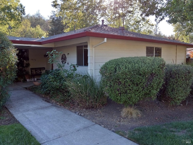 view of home's exterior featuring roof with shingles