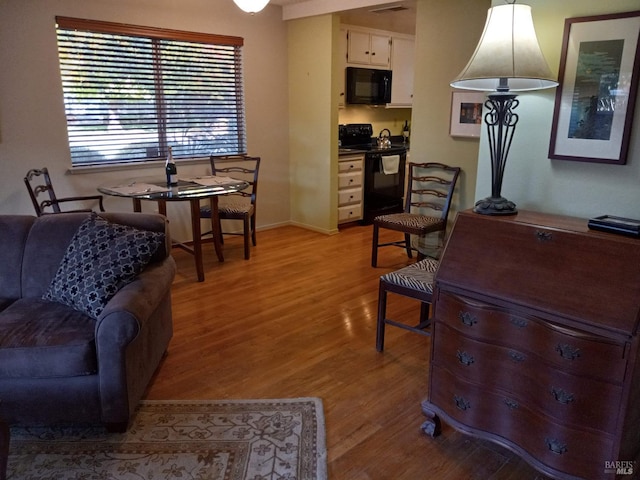 interior space featuring baseboards and light wood-style floors