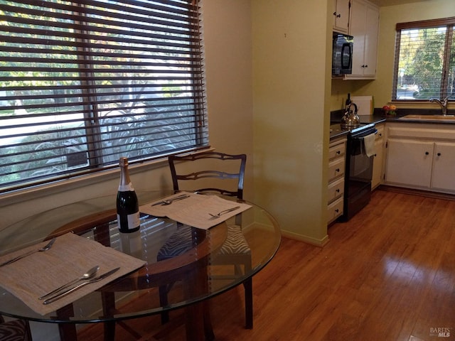 dining space with baseboards and light wood-style floors
