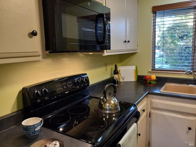 6472 Stone Bridge Rd, Santa Rosa, CA 95409 - kitchen featuring black appliances, a sink, white cabinetry, and healthy amount of natural light