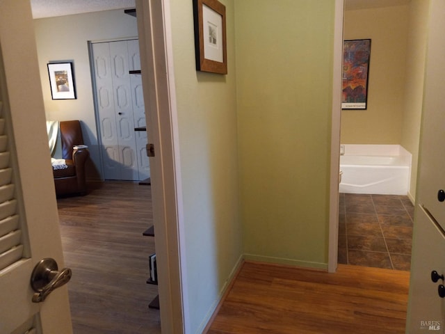 6472 Stone Bridge Rd, Santa Rosa, CA 95409 - hallway with dark wood-style flooring and baseboards