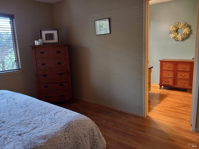 bedroom featuring baseboards and wood finished floors