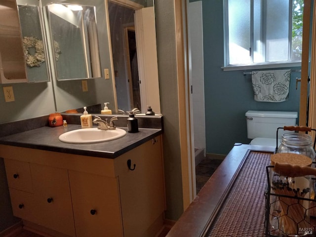 bathroom featuring toilet and vanity