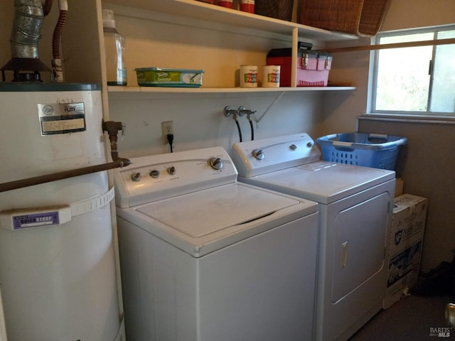 clothes washing area featuring washer and clothes dryer, secured water heater, and laundry area
