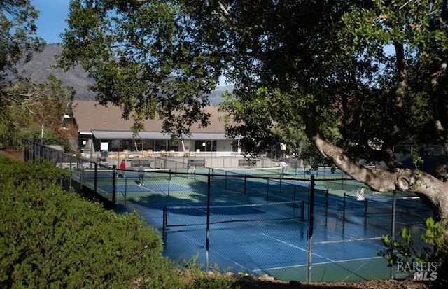 view of sport court featuring fence