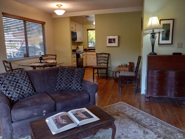 6472 Stone Bridge Rd, Santa Rosa, CA 95409 - living area featuring wood finished floors, baseboards, and a textured ceiling