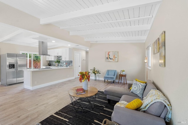 living room with beam ceiling and light hardwood / wood-style flooring