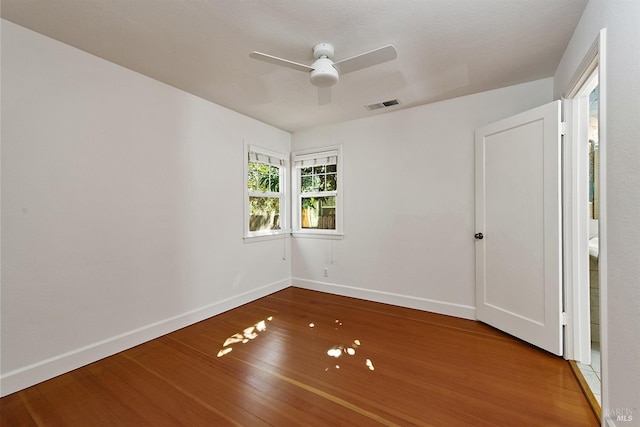 spare room with ceiling fan and hardwood / wood-style flooring