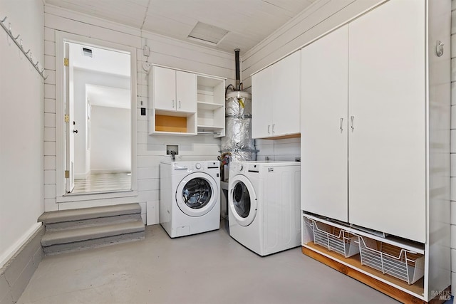 washroom with cabinets and washing machine and clothes dryer