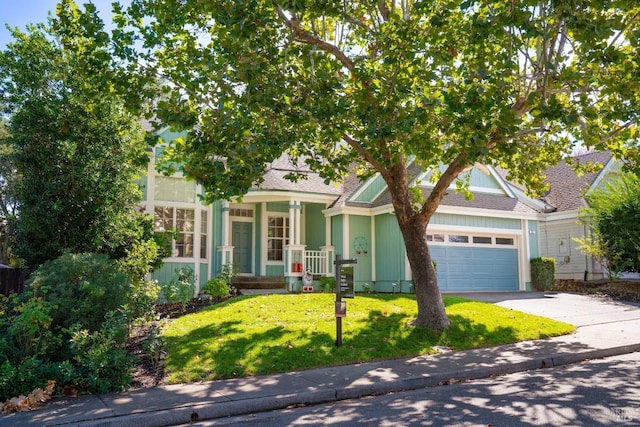 view of property hidden behind natural elements featuring a front yard, a garage, driveway, and roof with shingles