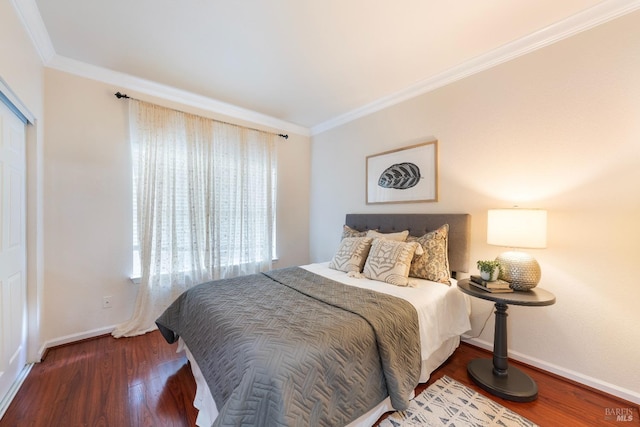 bedroom with baseboards, wood finished floors, and ornamental molding