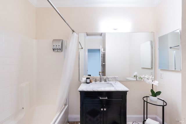 bathroom featuring vanity, crown molding, baseboards, and shower / bath combo with shower curtain