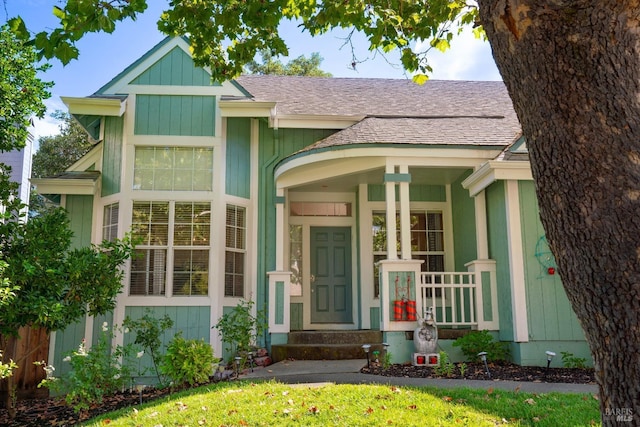 view of front of property featuring roof with shingles