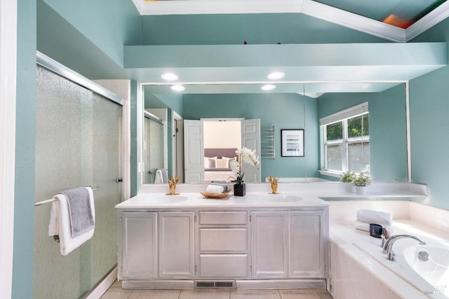 bathroom with visible vents, double vanity, tiled tub, a stall shower, and a sink