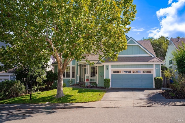 view of property hidden behind natural elements with a garage, roof with shingles, concrete driveway, and a front yard