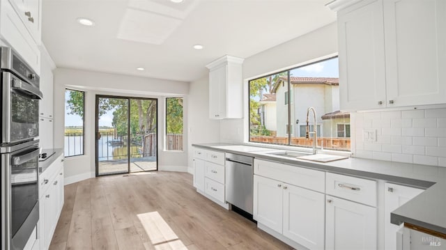 kitchen featuring white cabinets, light hardwood / wood-style floors, and plenty of natural light