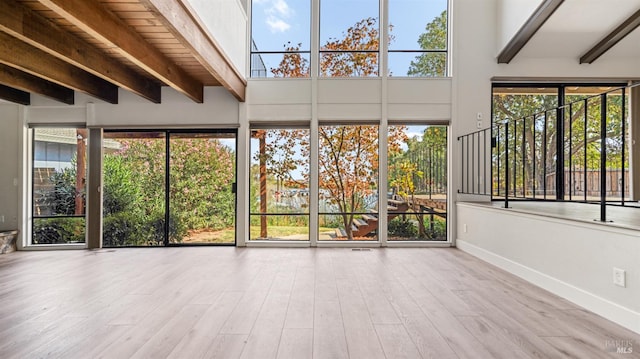 unfurnished sunroom with wooden ceiling and beamed ceiling