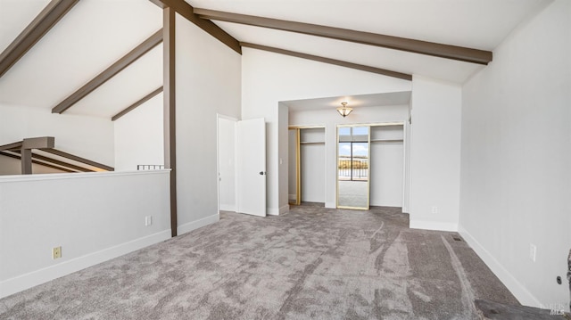 carpeted empty room featuring beamed ceiling and high vaulted ceiling