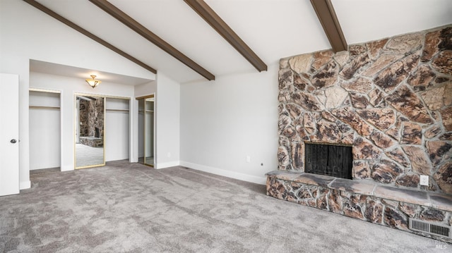 unfurnished living room with vaulted ceiling with beams, carpet, and a fireplace