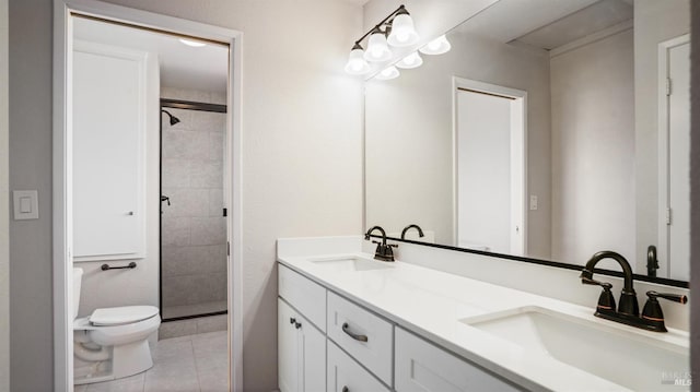 bathroom with tile patterned flooring, vanity, toilet, and an enclosed shower