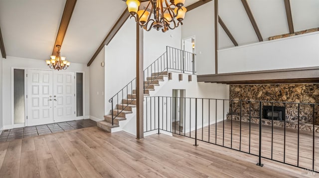 foyer entrance featuring high vaulted ceiling, wood-type flooring, and beamed ceiling