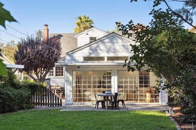 rear view of property with a patio area and a yard