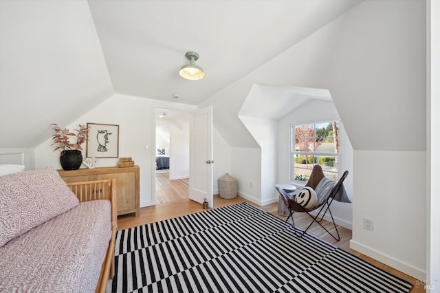 interior space with light hardwood / wood-style floors and lofted ceiling