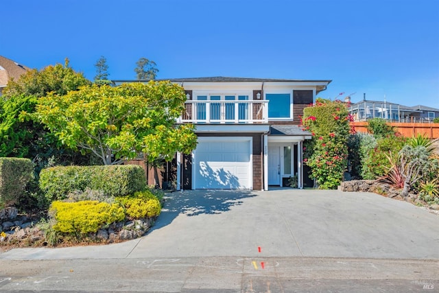 view of front of house featuring a balcony and a garage