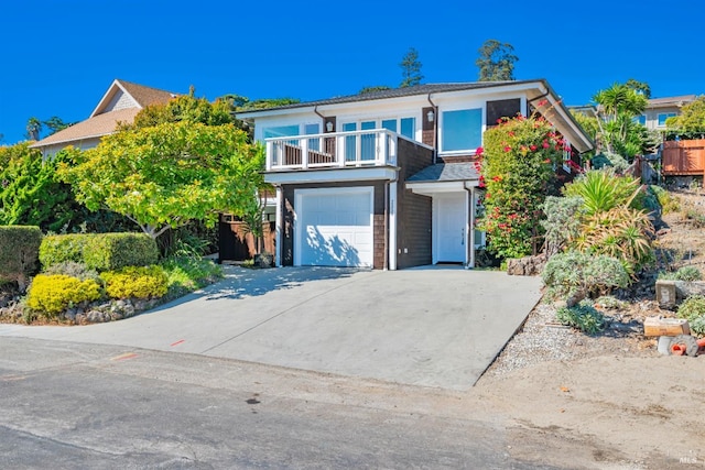 front facade featuring a balcony and a garage