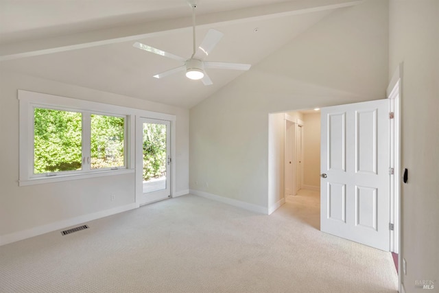 carpeted spare room with beam ceiling, ceiling fan, and plenty of natural light