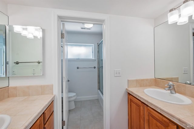 bathroom featuring tile patterned flooring, vanity, and toilet