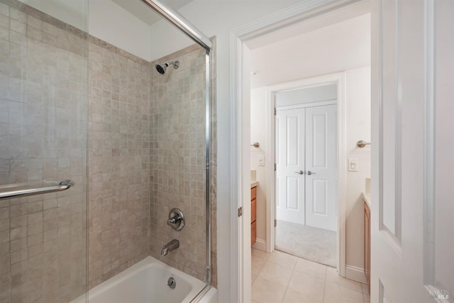 bathroom featuring enclosed tub / shower combo, vanity, and tile patterned floors