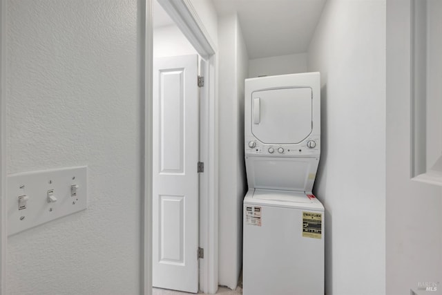 laundry area featuring stacked washing maching and dryer