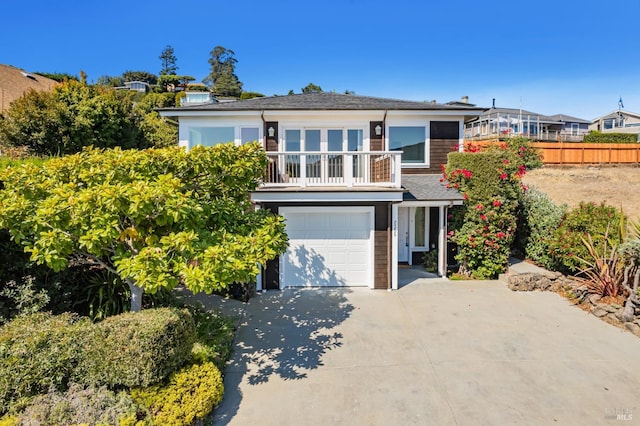 view of front of house featuring a balcony and a garage