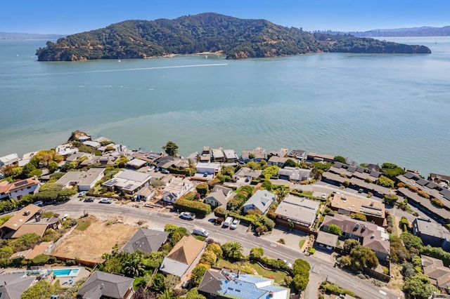 birds eye view of property with a water and mountain view