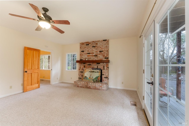 unfurnished living room with a fireplace, ceiling fan, and carpet flooring