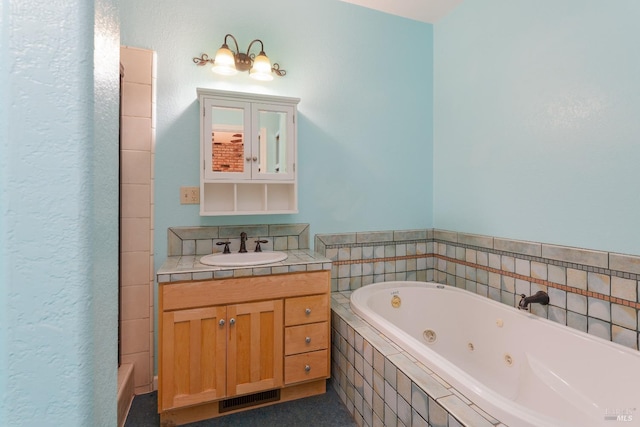 bathroom featuring vanity and tiled tub