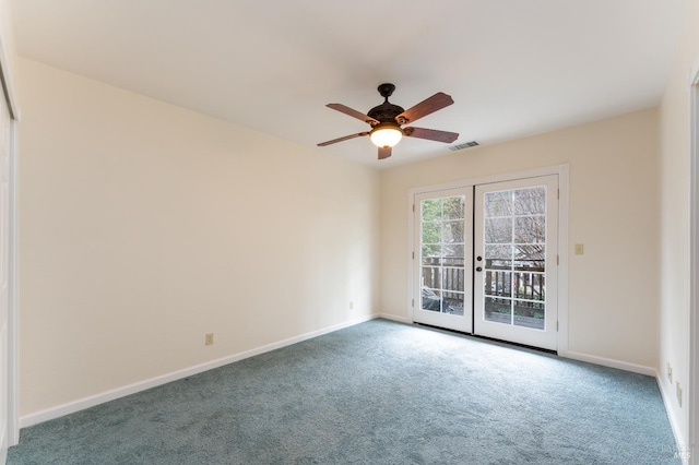 spare room featuring carpet, ceiling fan, and french doors