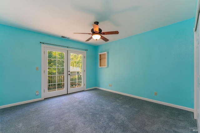 carpeted spare room featuring french doors and ceiling fan