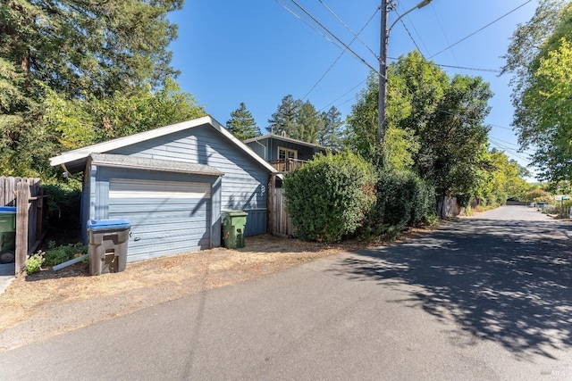 view of side of property featuring a garage and an outbuilding