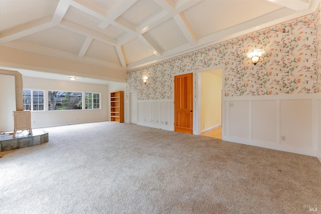 unfurnished living room featuring coffered ceiling, light colored carpet, and beamed ceiling