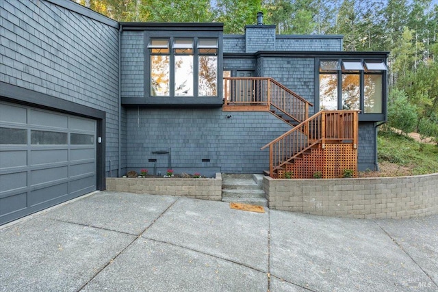 rear view of house featuring a garage